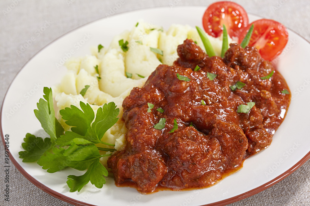 Goulash with mashed potatoes and tomato Goulash with mashed potatoes and tomato