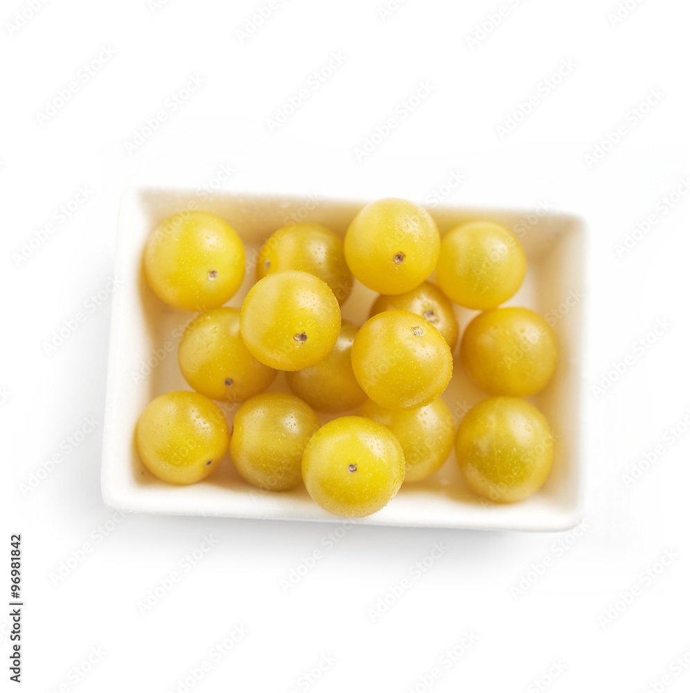 Dish full of ripe fresh yellow cherry tomatoes Dish full of ripe fresh yellow cherry tomatoes
