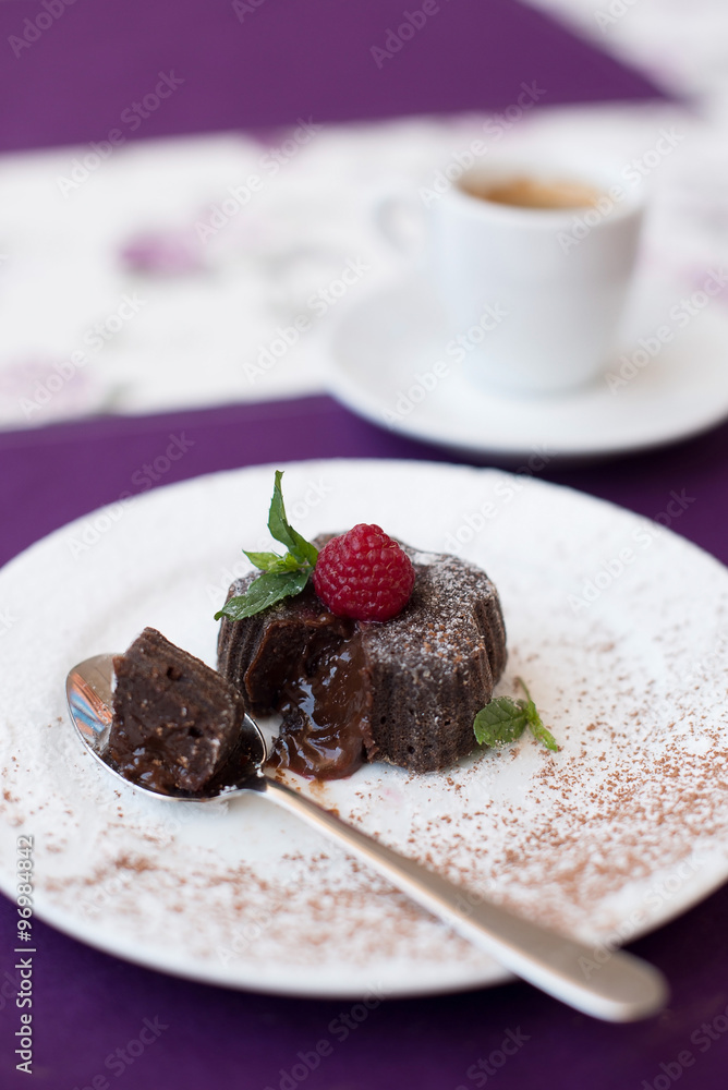 Chocolate fondant on a white plate and coffee Chocolate fondant on a white plate and coffee