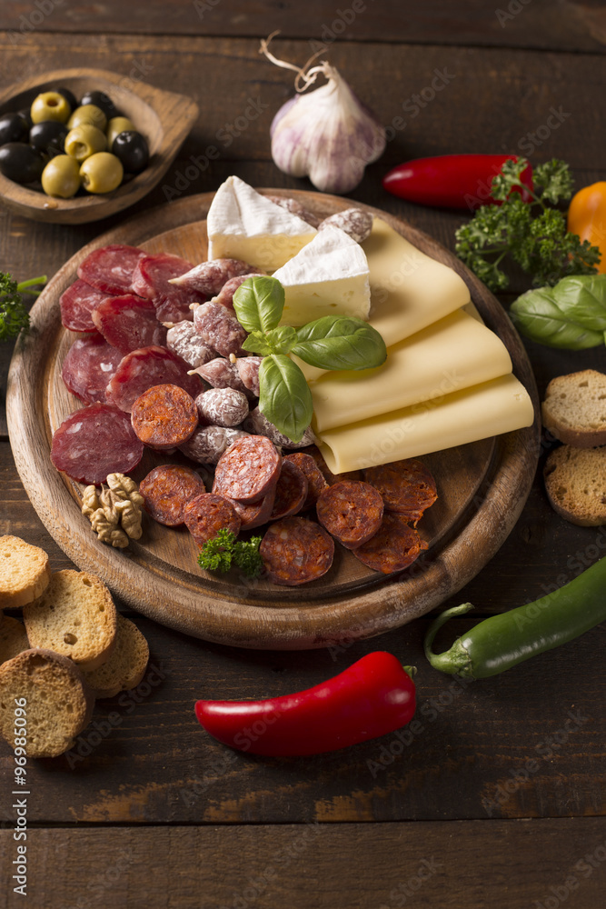 appetizer with sausages,cheese,olive and nuts