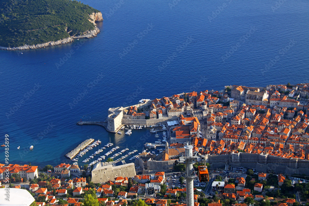 Dubrovnik old town viewed from a nearby hill with a cable car connection.