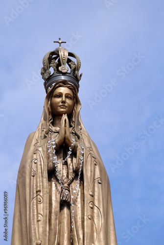 statue of our Lady with clasped hands and the precious Crown