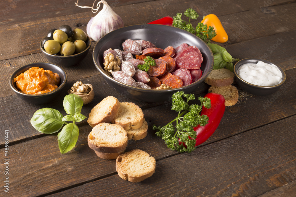 appetizer with sausages,pesto,olive and nuts appetizer with sausages,pesto,olive and nuts
