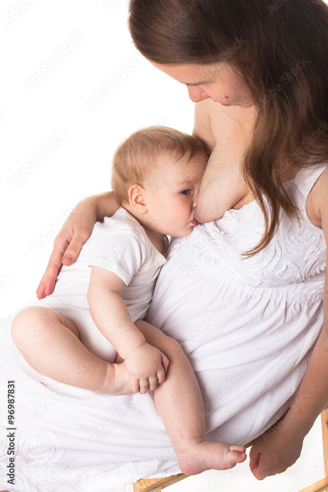 Mom feeds the baby breast, light background Mom feeds the baby breast, light background