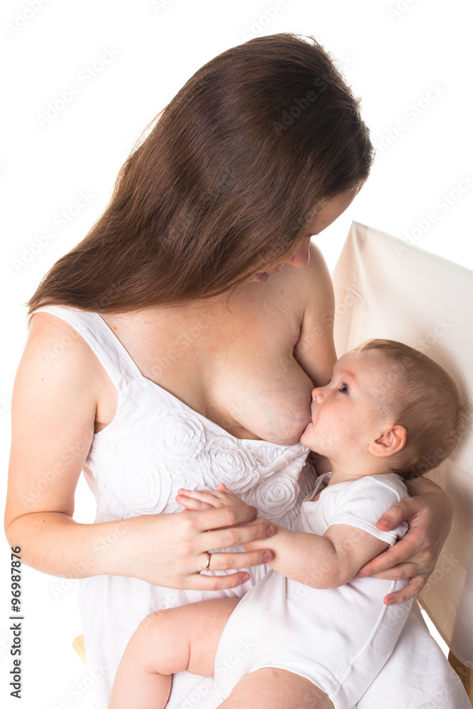 Mom feeds the baby breast, light background Mom feeds the baby breast, light background