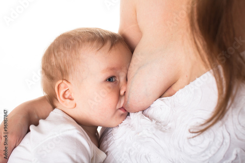 Mom feeds the baby breast, light background