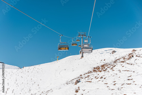 Ski lifts durings bright winter day photo