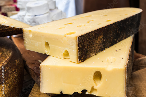 Two large pieces of Emmental cheese on the wooden table