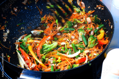 stir fried vegetables in the pan and pasta