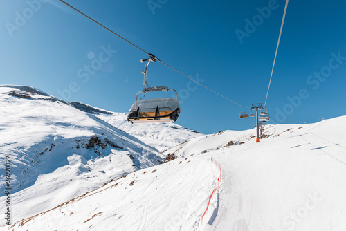 Ski lifts durings bright winter day photo