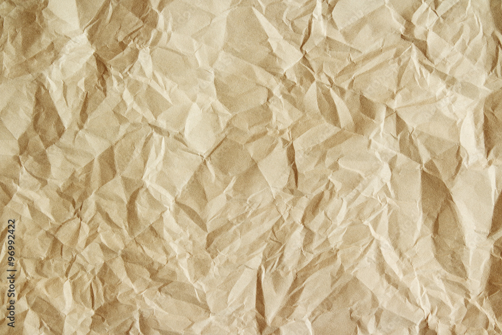 Obraz premium Old crumpled parchment texture. Beige paper sheet as background.