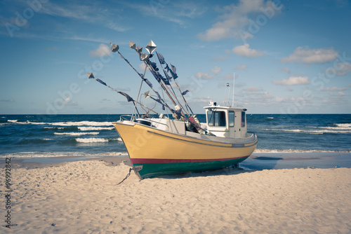 Fototapeta Naklejka Na Ścianę i Meble -  Old fishing boat on a beach