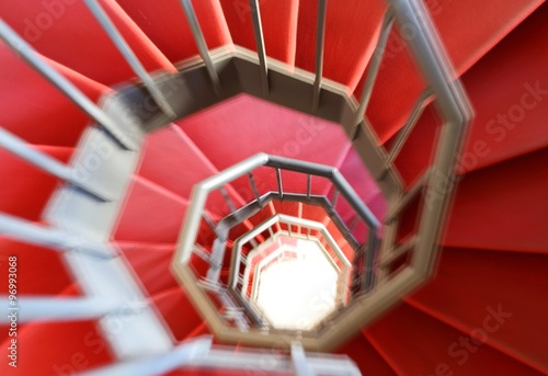 spiral staircase with moving steps and the red carpet