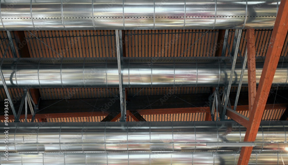 great pipes of a heating and air-conditioning under the roof of