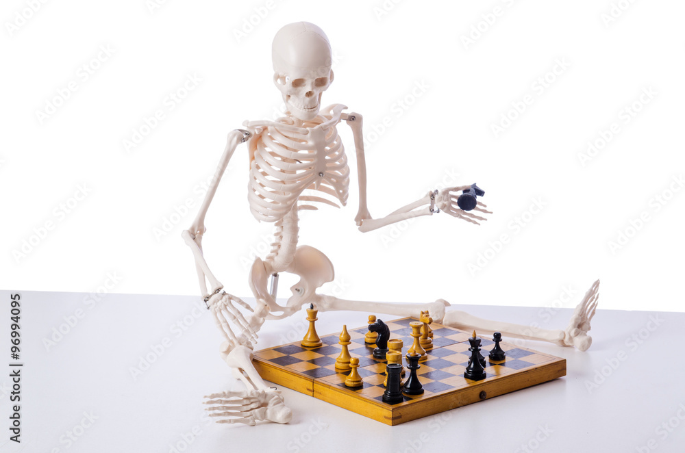 Skeleton playing chess game on white