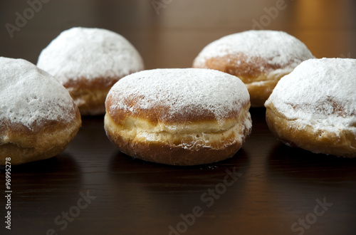donut with powder sugar against dark background