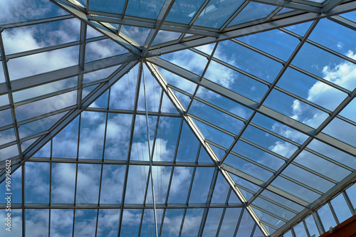 View of the clouds in the sky through the glass roof.