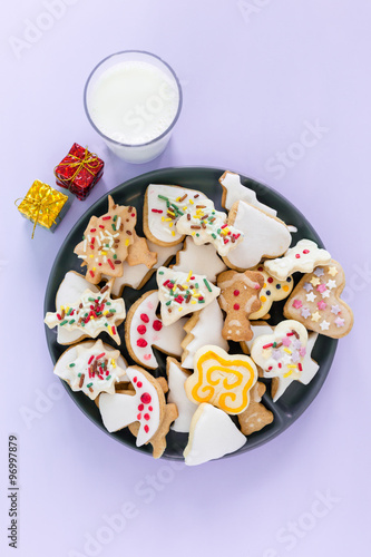 Cookie with milk and christmas tree on the table for Santa Claus