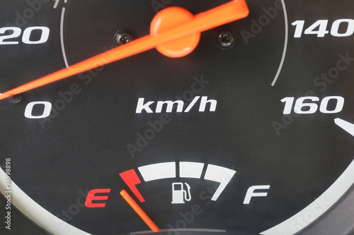 Fuel gauge with warning indicating low fuel tank.