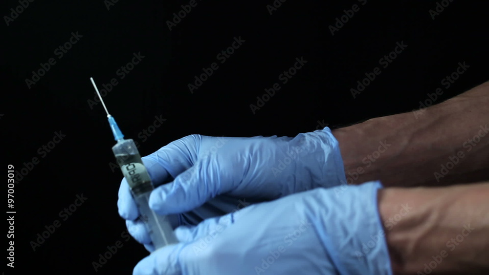 The doctor prepares an injection The doctor prepares an injection