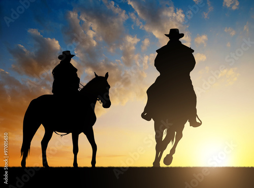 Silhouette cowboy with horse in the sunset © vencav
