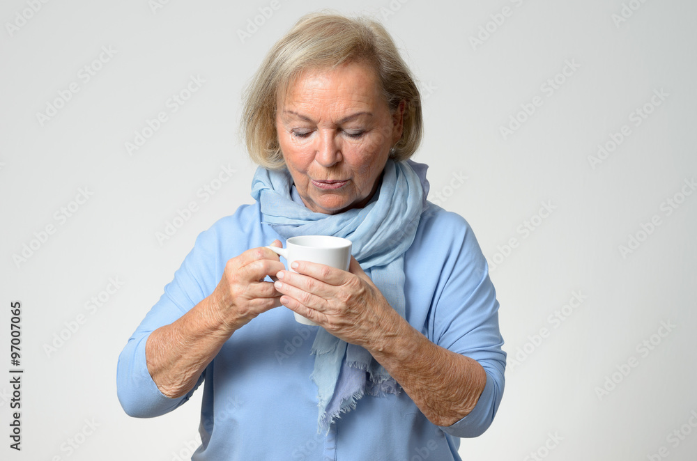 Elderly woman enjoying a hot cup of coffee Elderly woman enjoying a hot cup of coffee