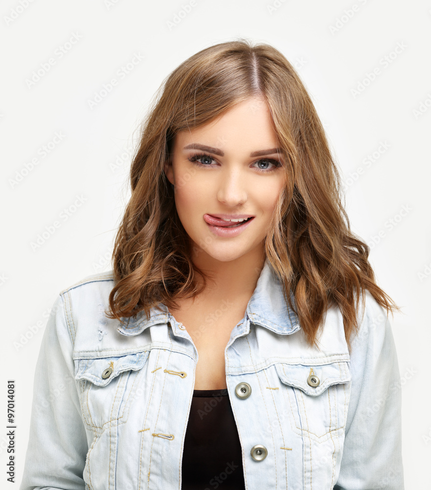 Portrait of attractive girl sticking out her tongue. Portrait of attractive girl sticking out her tongue.