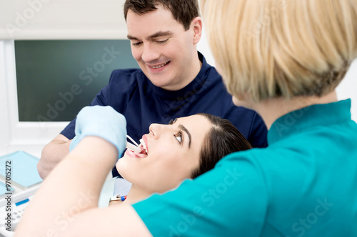 Lady getting her teeth cleaned by dentist