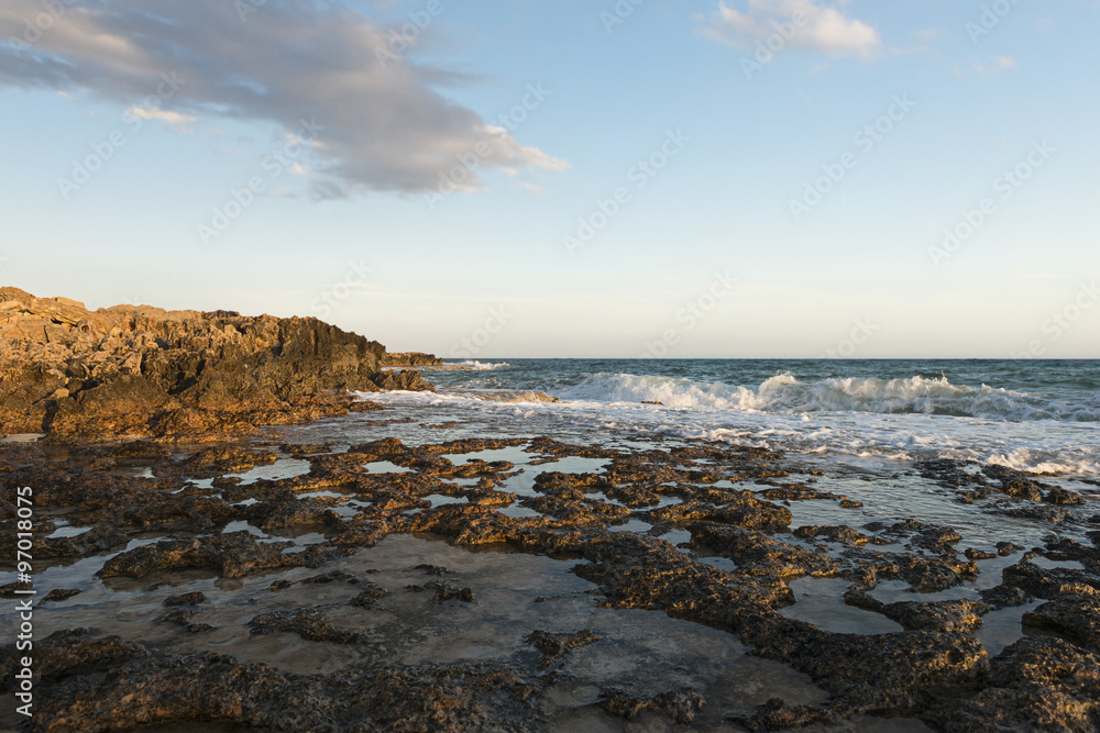 Rocky shore. Sunset over the sea