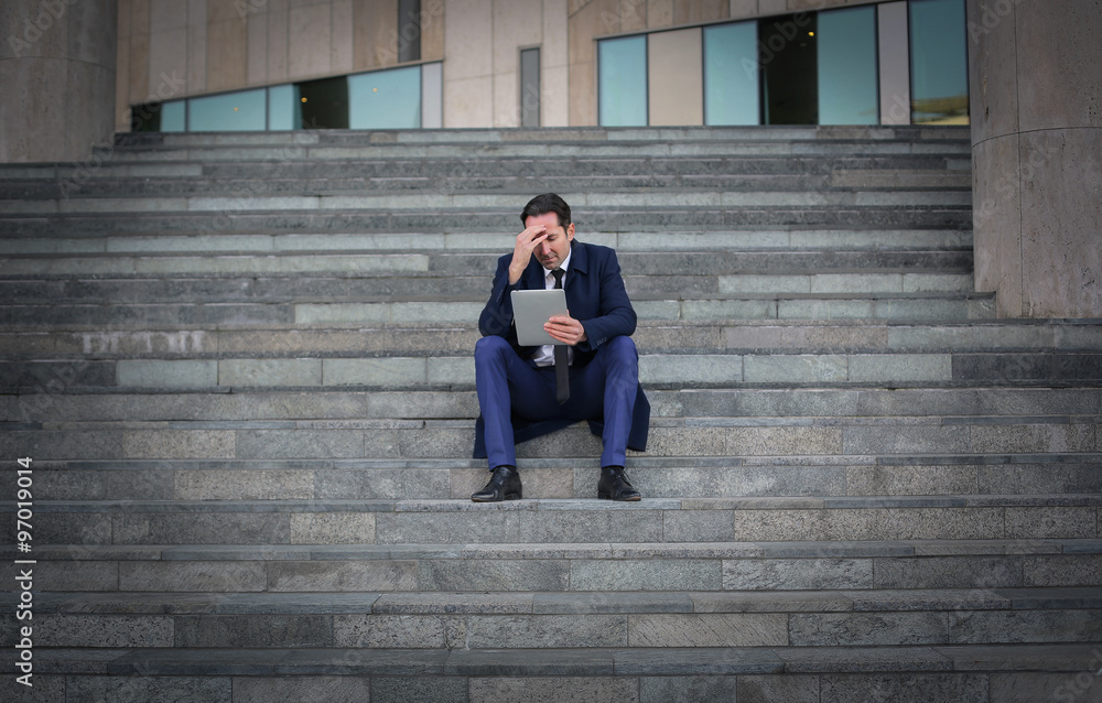 Businessman sitting on the ground Businessman sitting on the ground