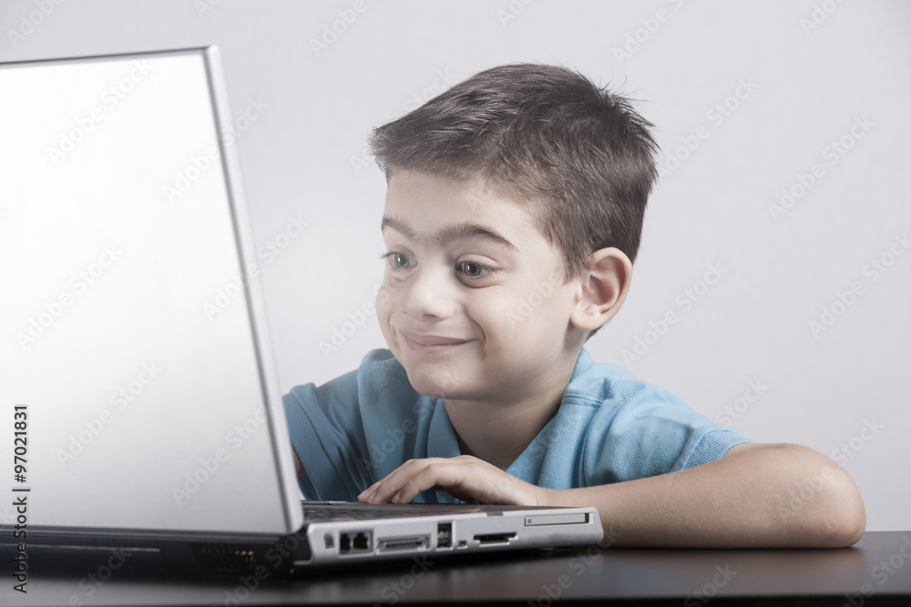 Boy reacts while using a laptop Boy reacts while using a laptop