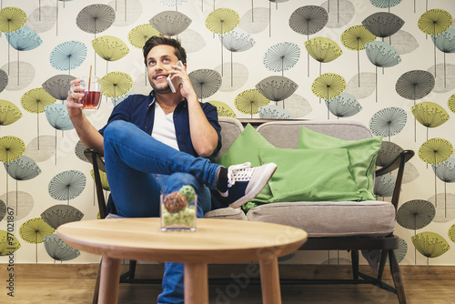 Bar smart casual young man talking on smartphone. photo