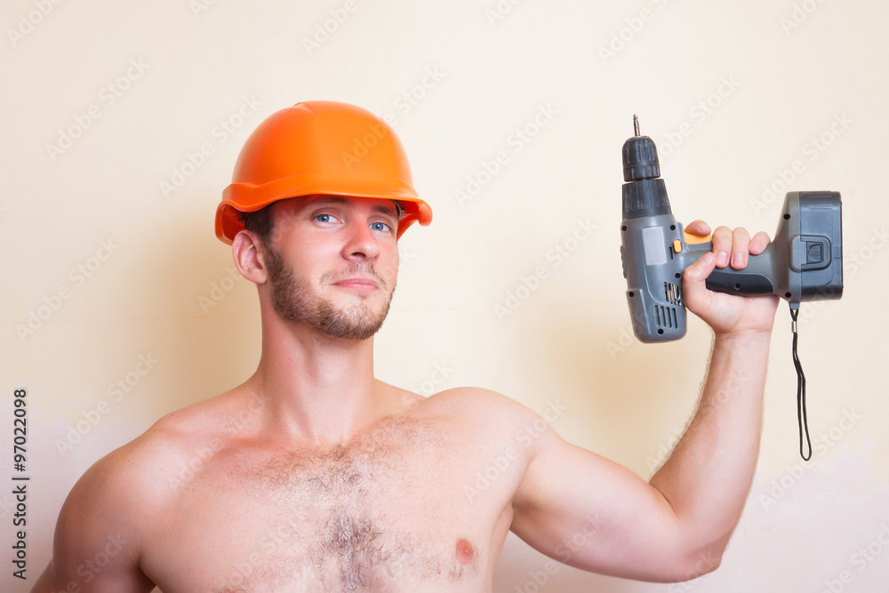 Man in helmet with a screwdriver Man in helmet with a screwdriver