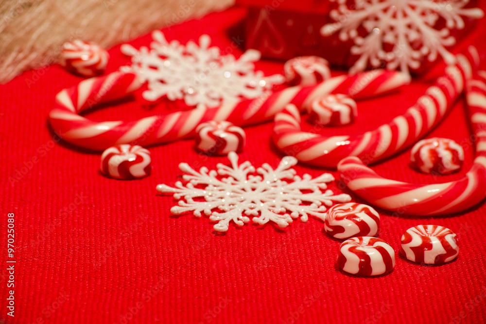 Christmas composition with red-white candies and snowflakes on a Christmas composition with red-white candies and snowflakes on a