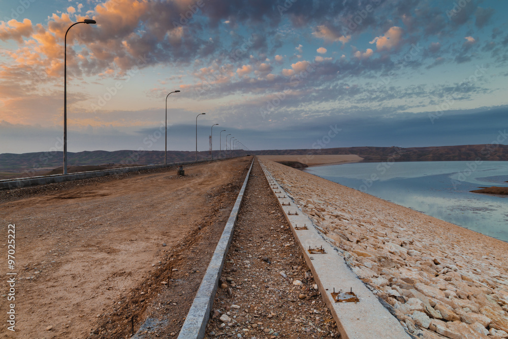 Unpaved road near a lake in Iraqi desert