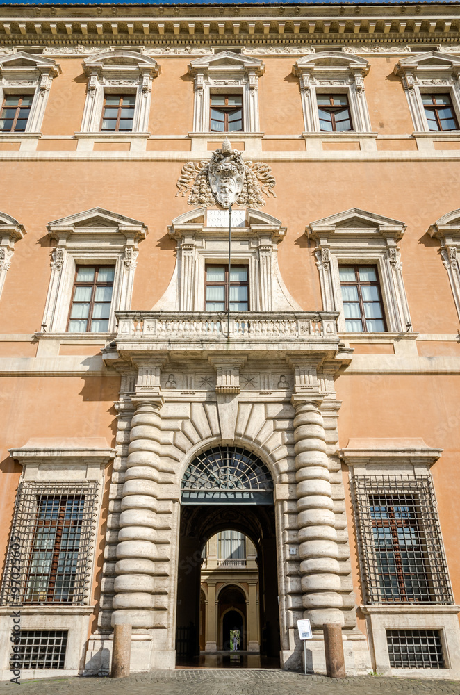 Building Lateranense Palace with a gate for the entry of vehicles and columns, as well as architectural ornaments windows in Rome, capital of Italy