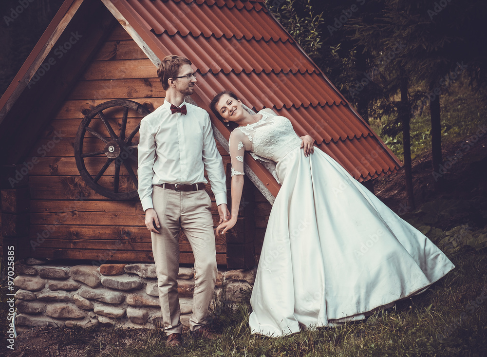 A young bride and groom standing together outdoor