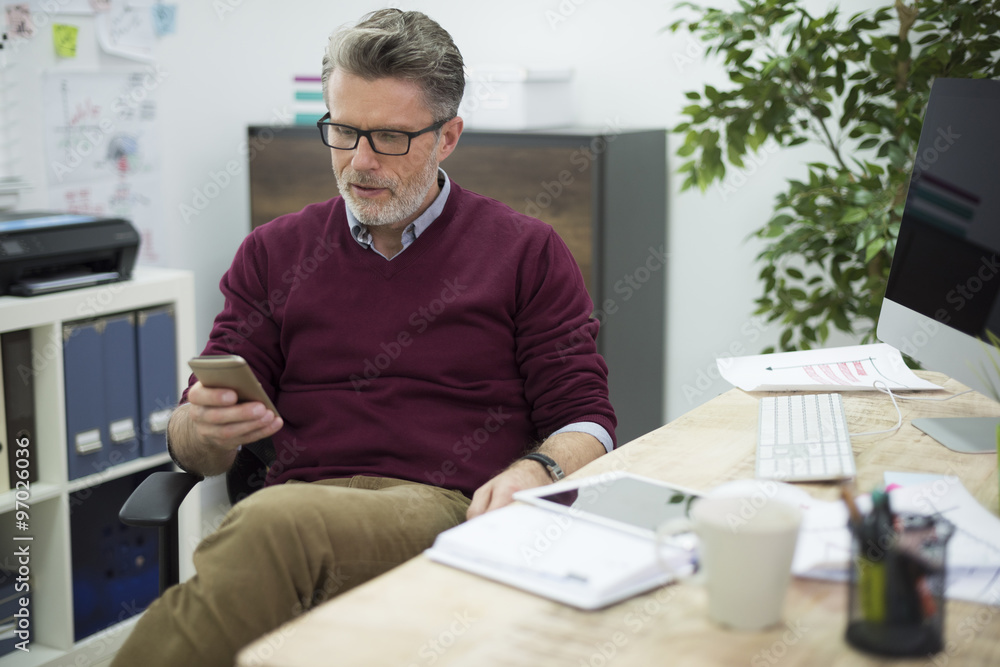 Fototapeta premium Manager of the company texting in the office