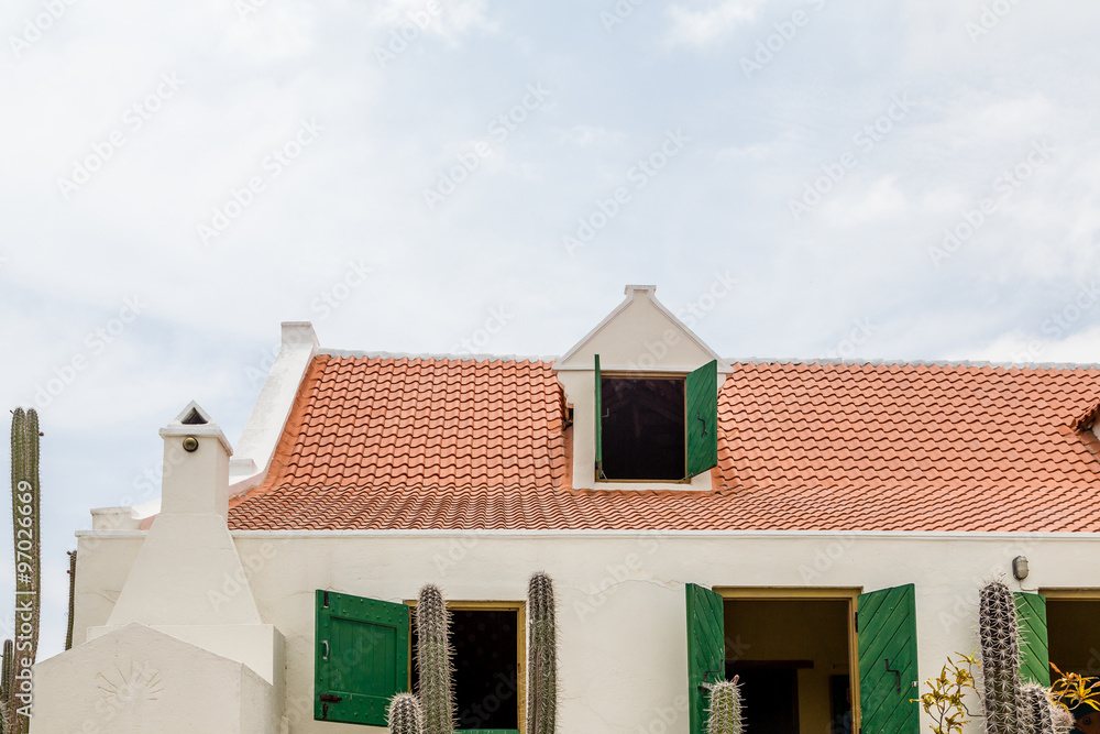 Red Tile Roof and Green Shutters on White Plaster