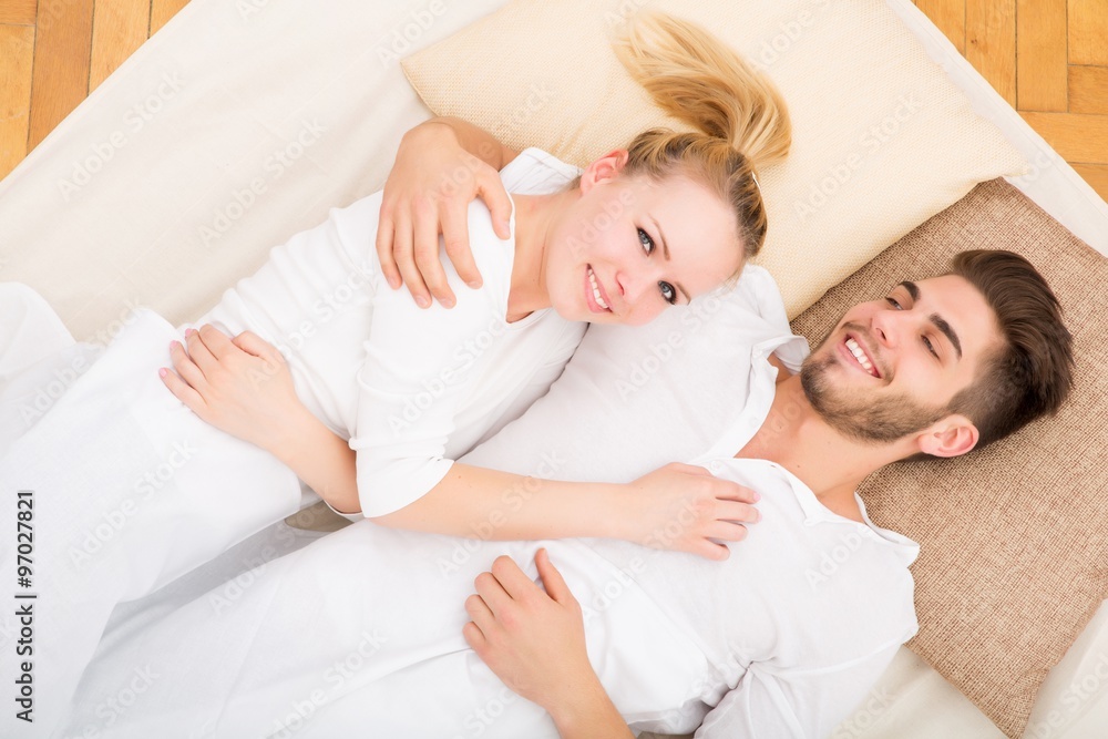 Young couple with a Tablet PC in Bed Young couple with a Tablet PC in Bed