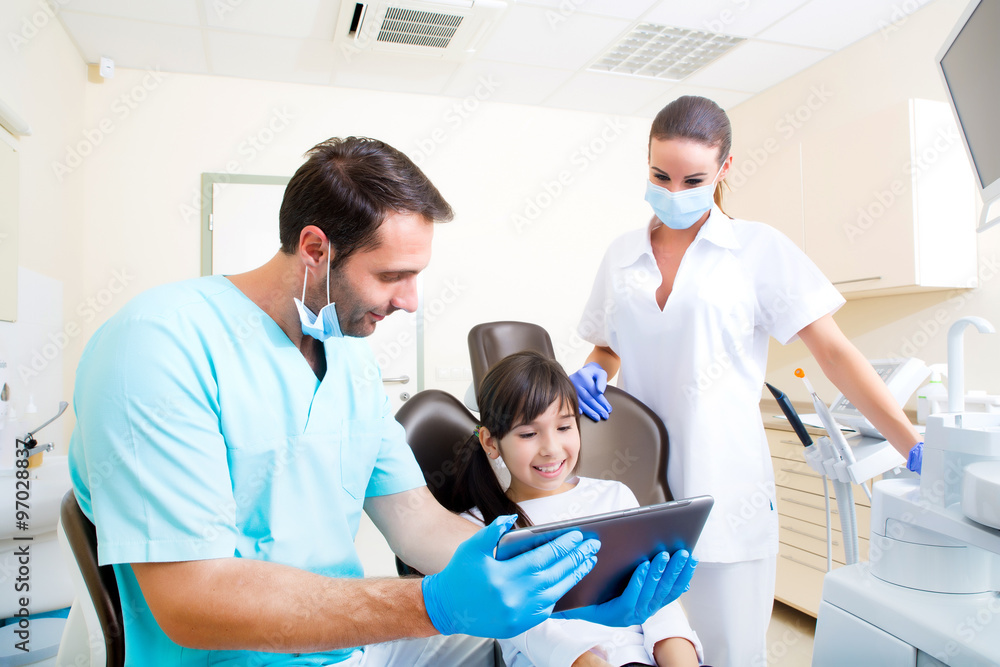 Dentist with a little girl and a Tablet PC. Dentist with a little girl and a Tablet PC.