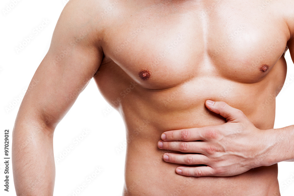 Muscled man holding his belly in pain, isolated on white backgro Muscled man holding his belly in pain, isolated on white backgro