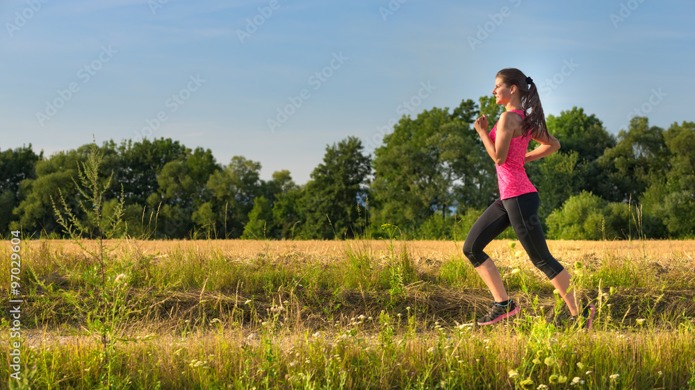 Attractive young female jogging in countryside Attractive young female jogging in countryside