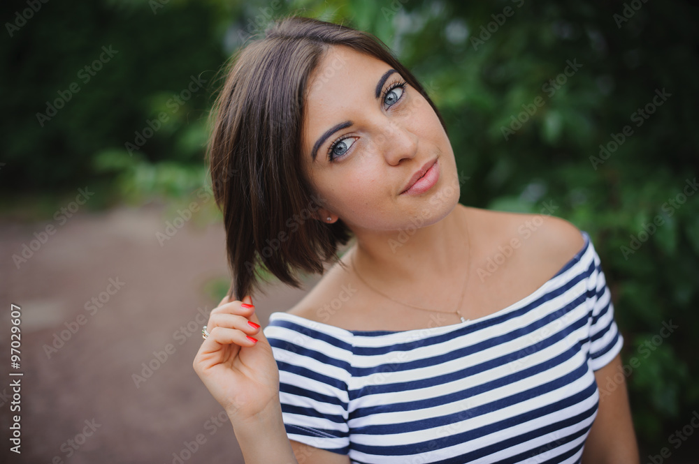 Closeup portrait of a bobbed haired young woman in park Closeup portrait of a bobbed haired young woman in park