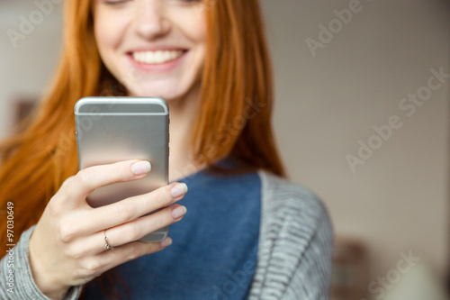 Redhead woman using smartphone