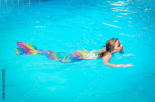 Mermaid girl swimming in the pool