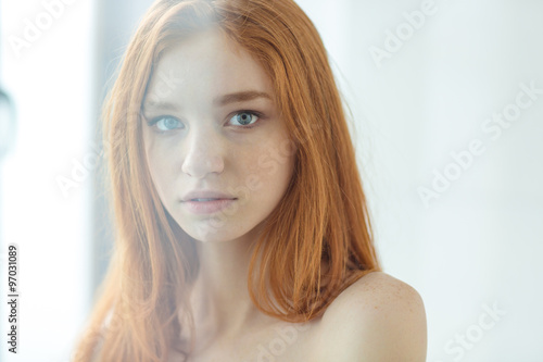 Charming redhead woman looking at camera