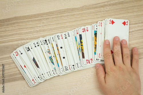 Hand touches deck of cards