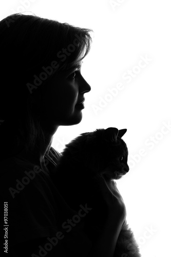 silhouette of a woman with a cat in her arms