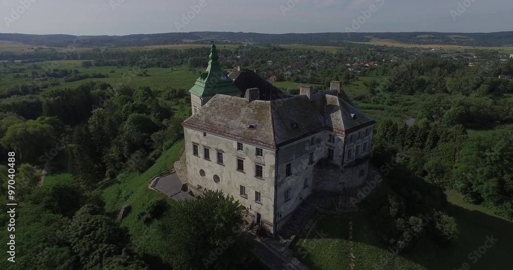 Medieval Olesko castle near Lviv city, Ukraine. It stands on a picturesque hill. Aerial view. Medieval Olesko castle near Lviv city, Ukraine. It stands on a picturesque hill. Aerial view.
